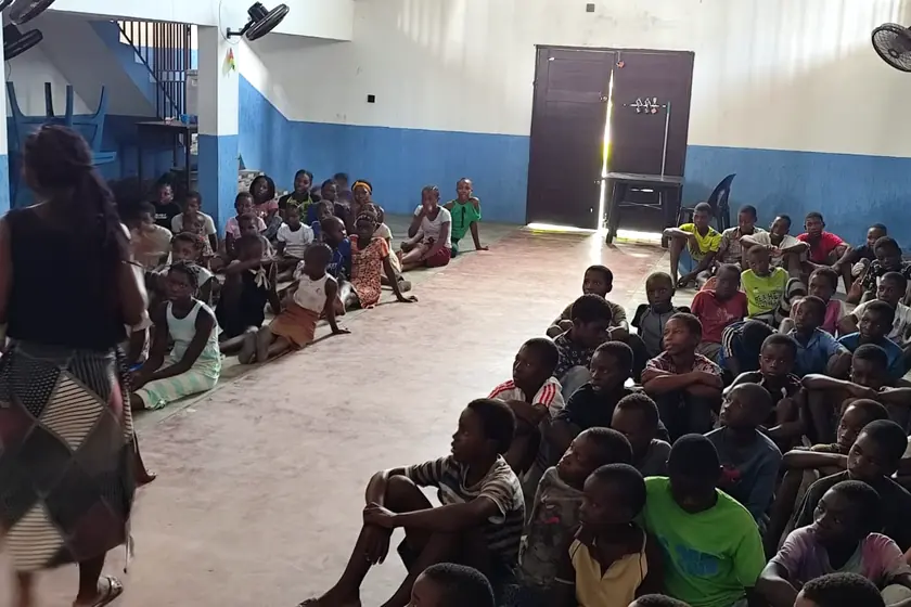 Children listening during a gathering at the mission